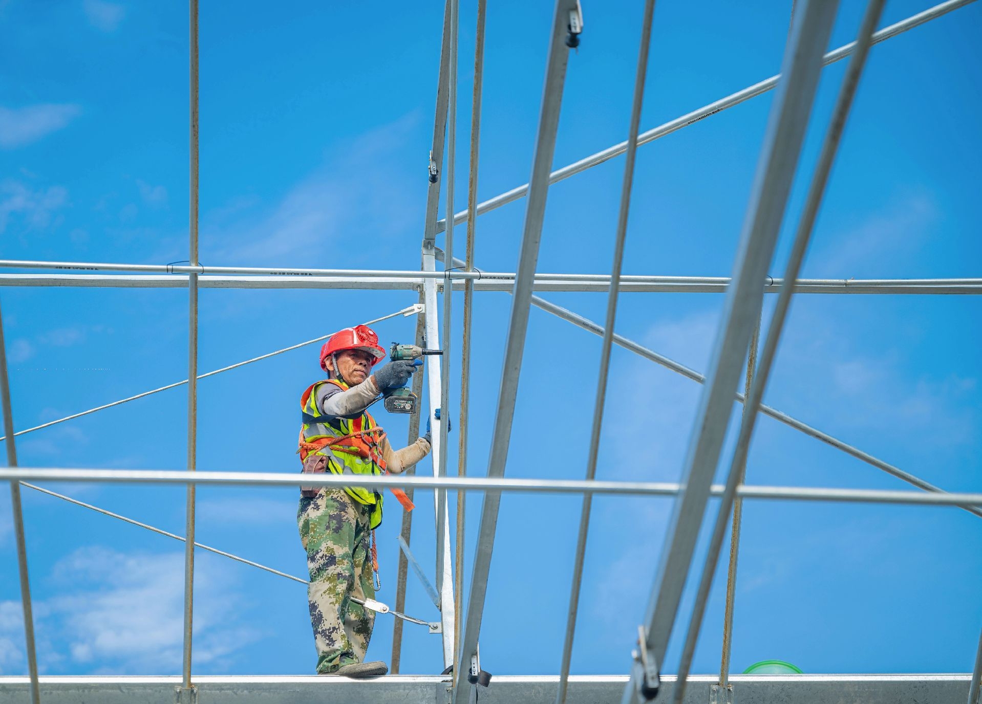 Greenhouse worker checking installation details